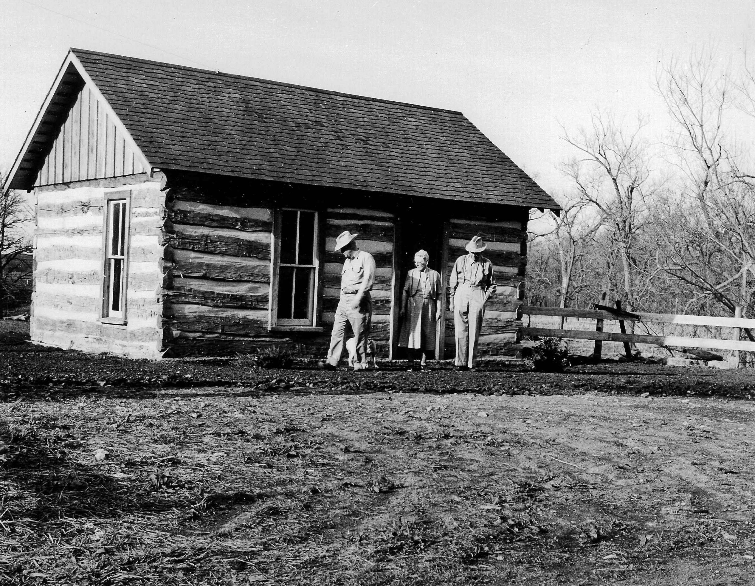 1960 – The Roglers inspect a log cabin moved in from another Rogler family’s plot. The Commemorative Log Cabin was restored in 1960 from one of the original Rogler cabins built after the family settled in the area in 1859.