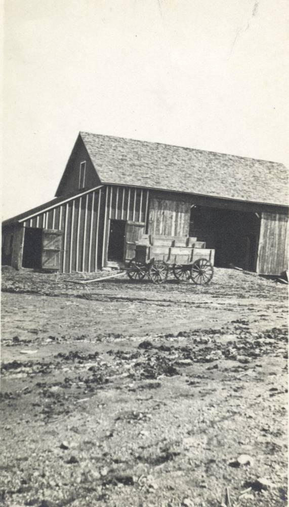 Irene on horseback in front of the old red barn